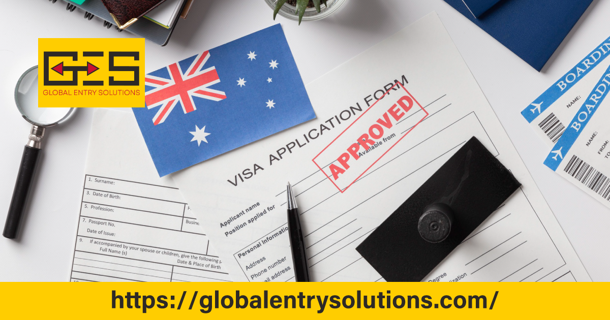 A professional working at a desk with a Australian flag and visa documents